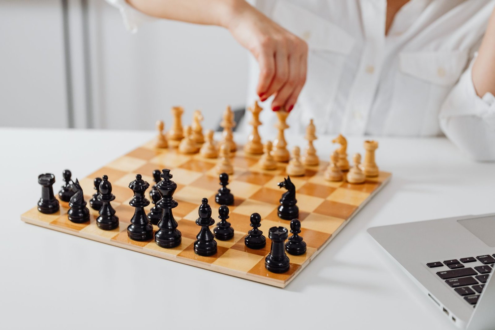 A chess board with three chess pieces representing cloud providers, labeled with AI model names, as a businessperson looks on deciding their next move.