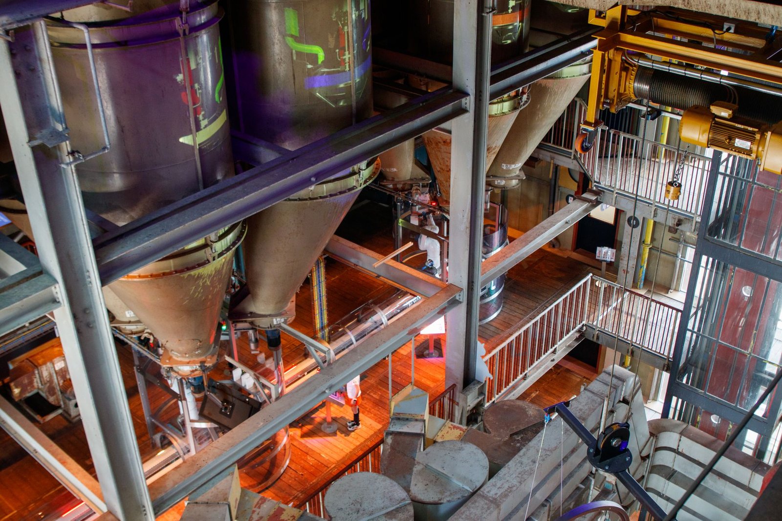 Rows of industrial pressure vessels and filtration pipes in a modern critical mineral processing facility