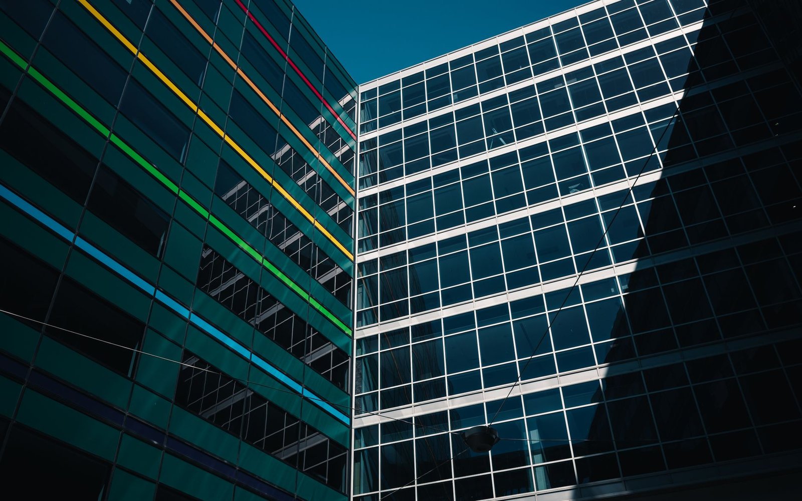 Modern glass office building with Rackspace signage, surrounded by lush greenery, conveying enterprise cloud and managed services
