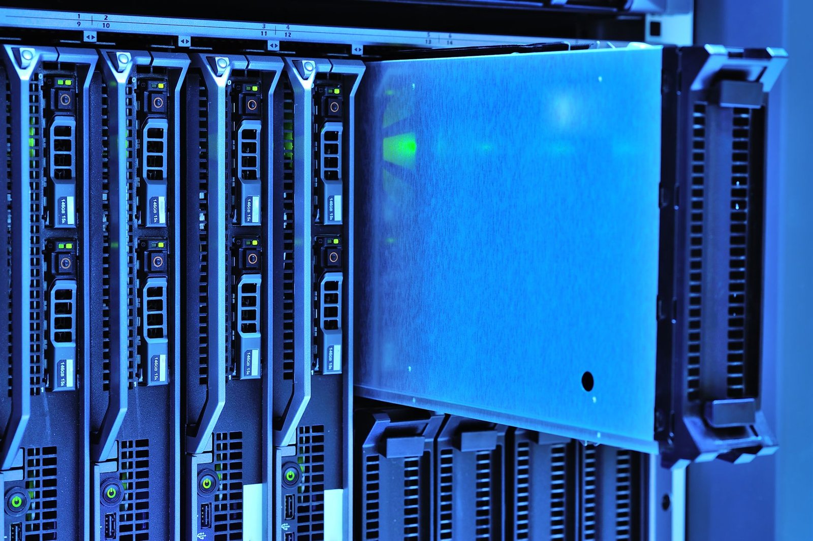 Two engineers in a data center discussing a tablet showing system performance metrics, with server racks in the background