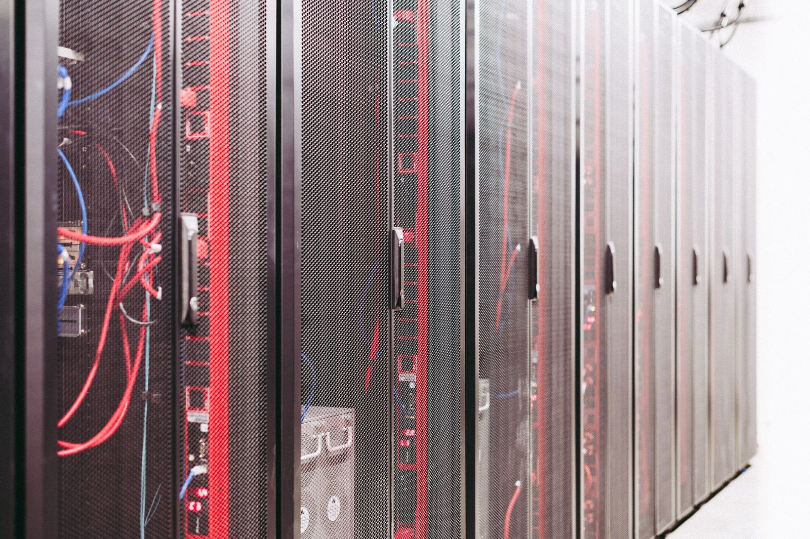 Rows of high-performance servers in a data center with glowing lights, representing AI computing infrastructure