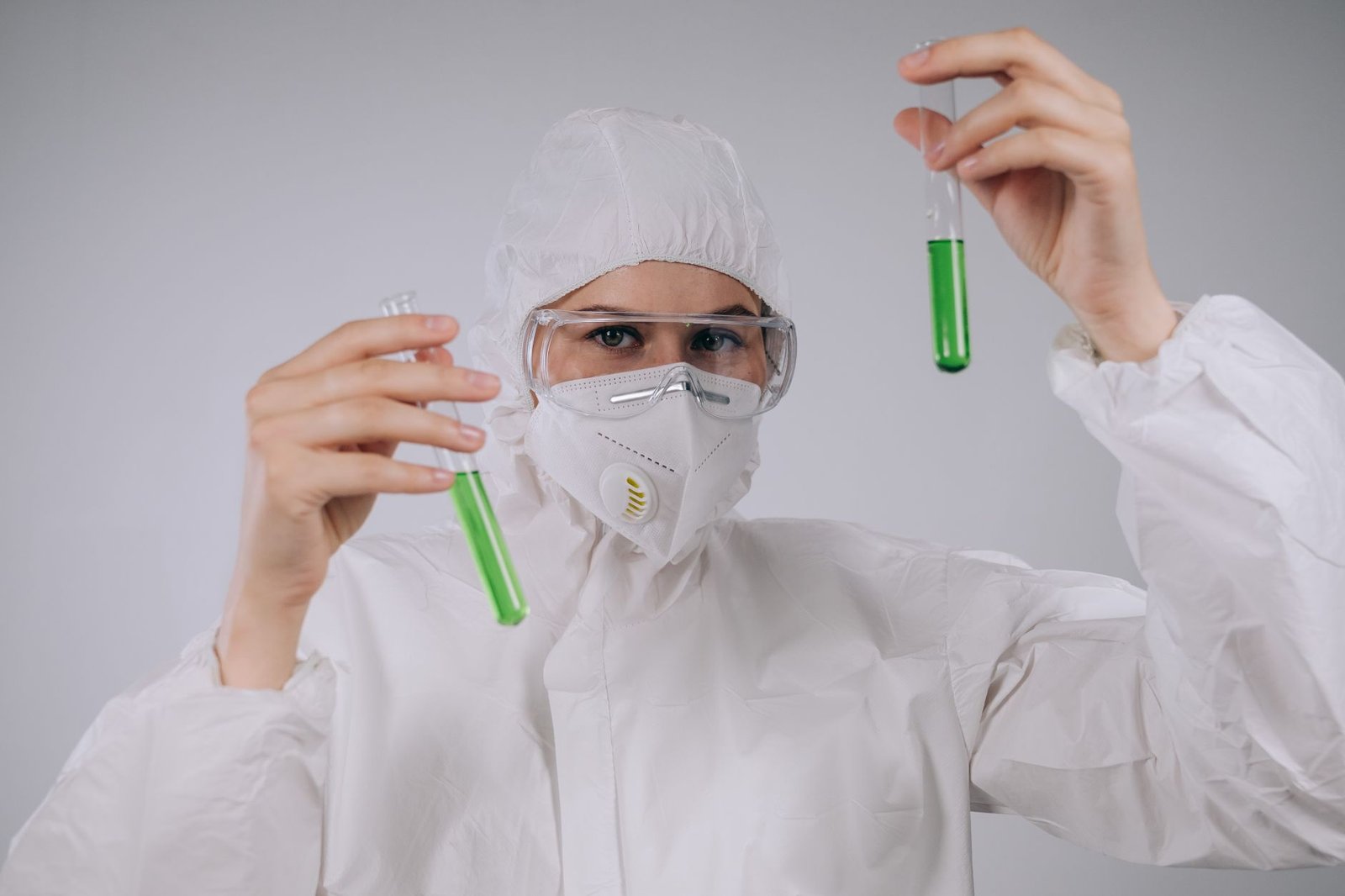 A researcher in a modern lab coat, illuminated by the glow of a computer monitor displaying molecular structures and data charts, symbolizing advanced scientific analysis.