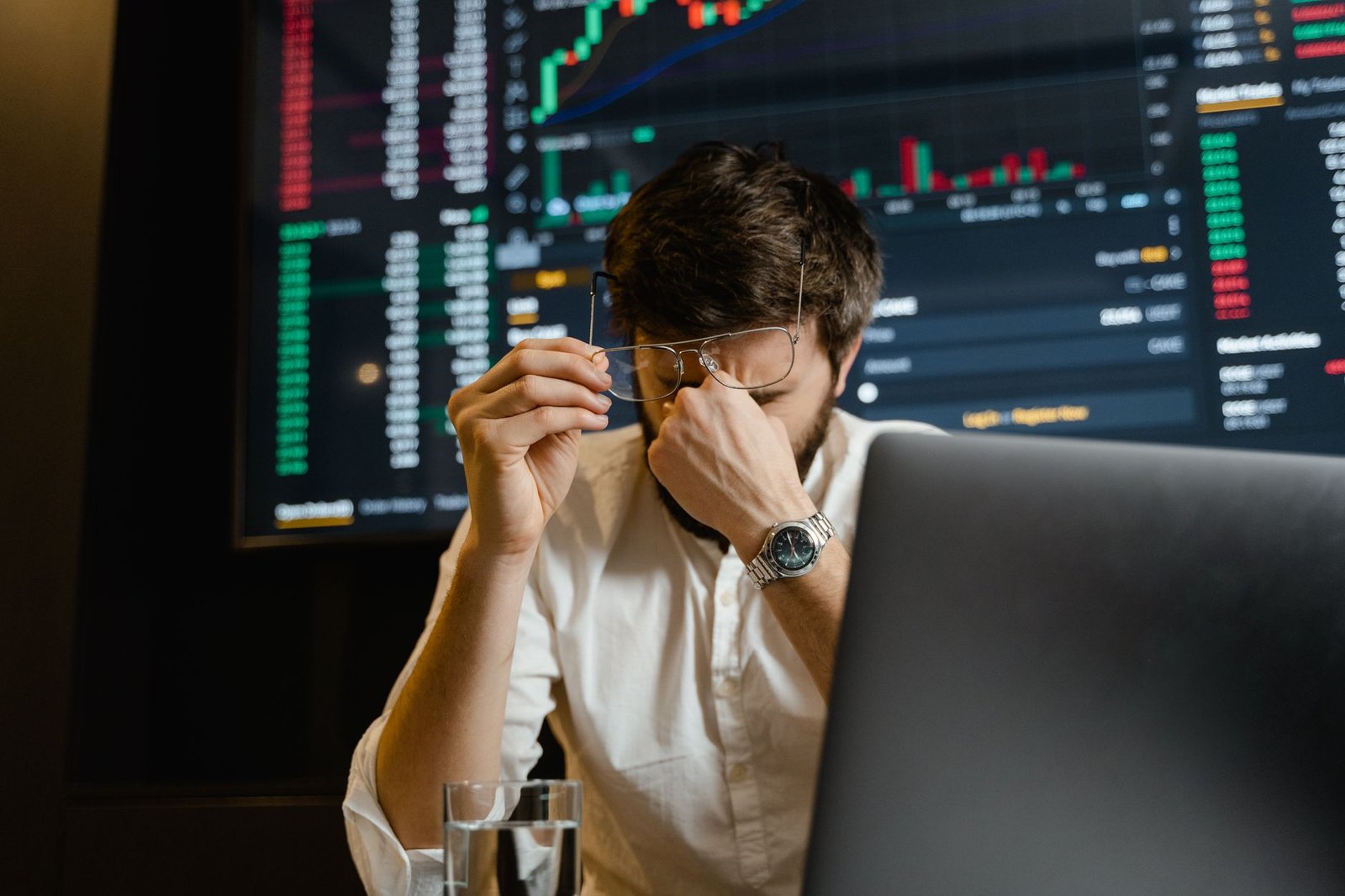 A frustrated CTO looking at a dashboard displaying failed AI project metrics on a laptop screen