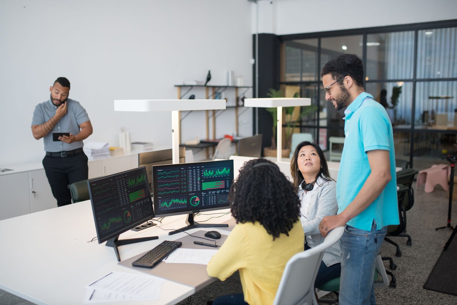 Two IT professionals in a server room reviewing a tablet with data center diagrams