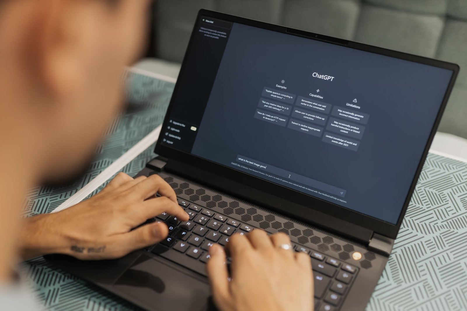 ChatGPT interface displayed on a modern laptop screen in a corporate office setting, with data visualizations and code visible