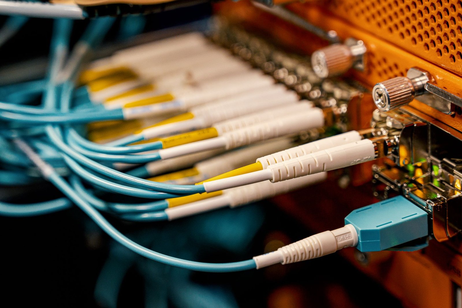 Rows of server racks in a modern telecommunications data center with blinking lights