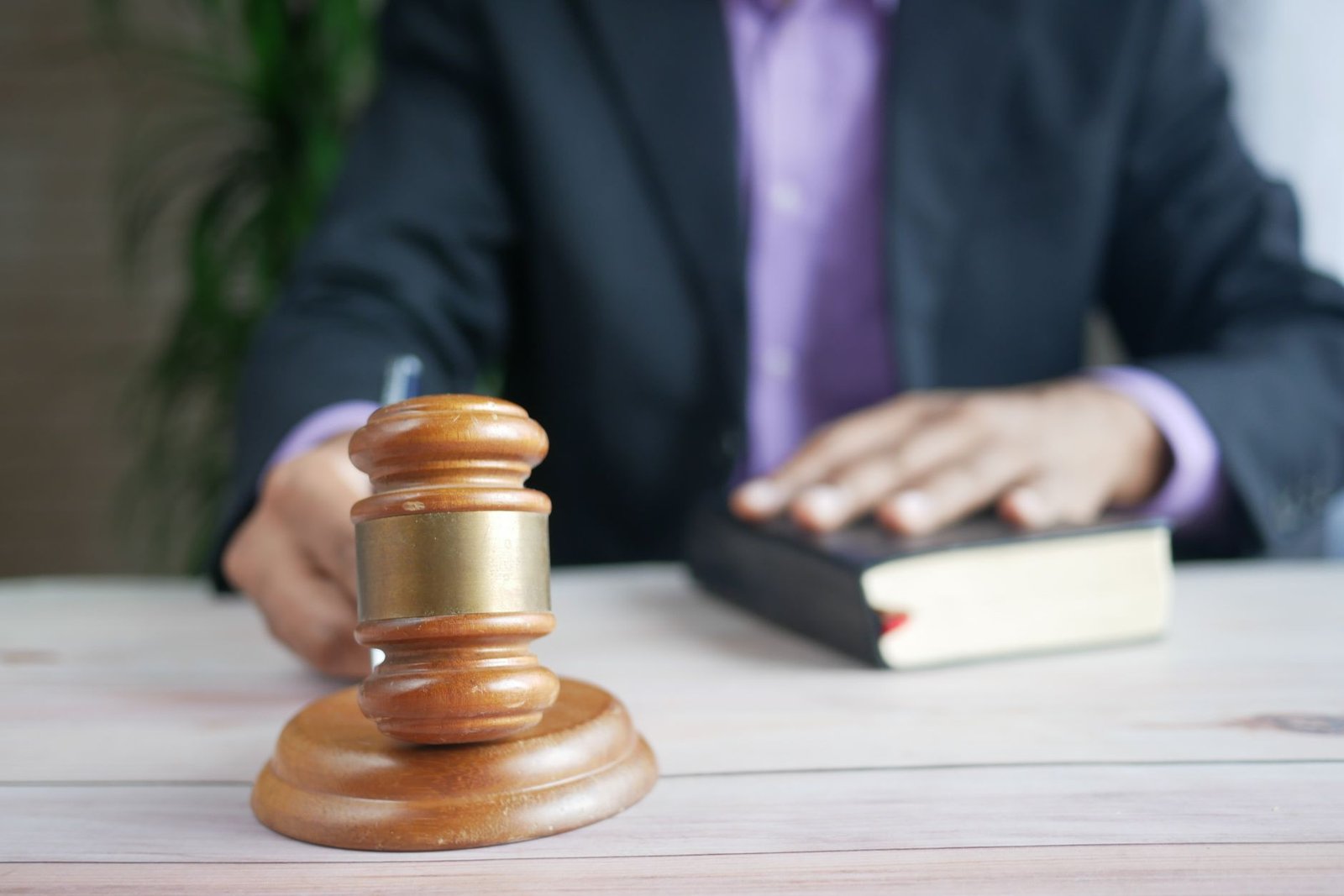 Law book with gavel on a desk, symbolizing legal disputes in technology