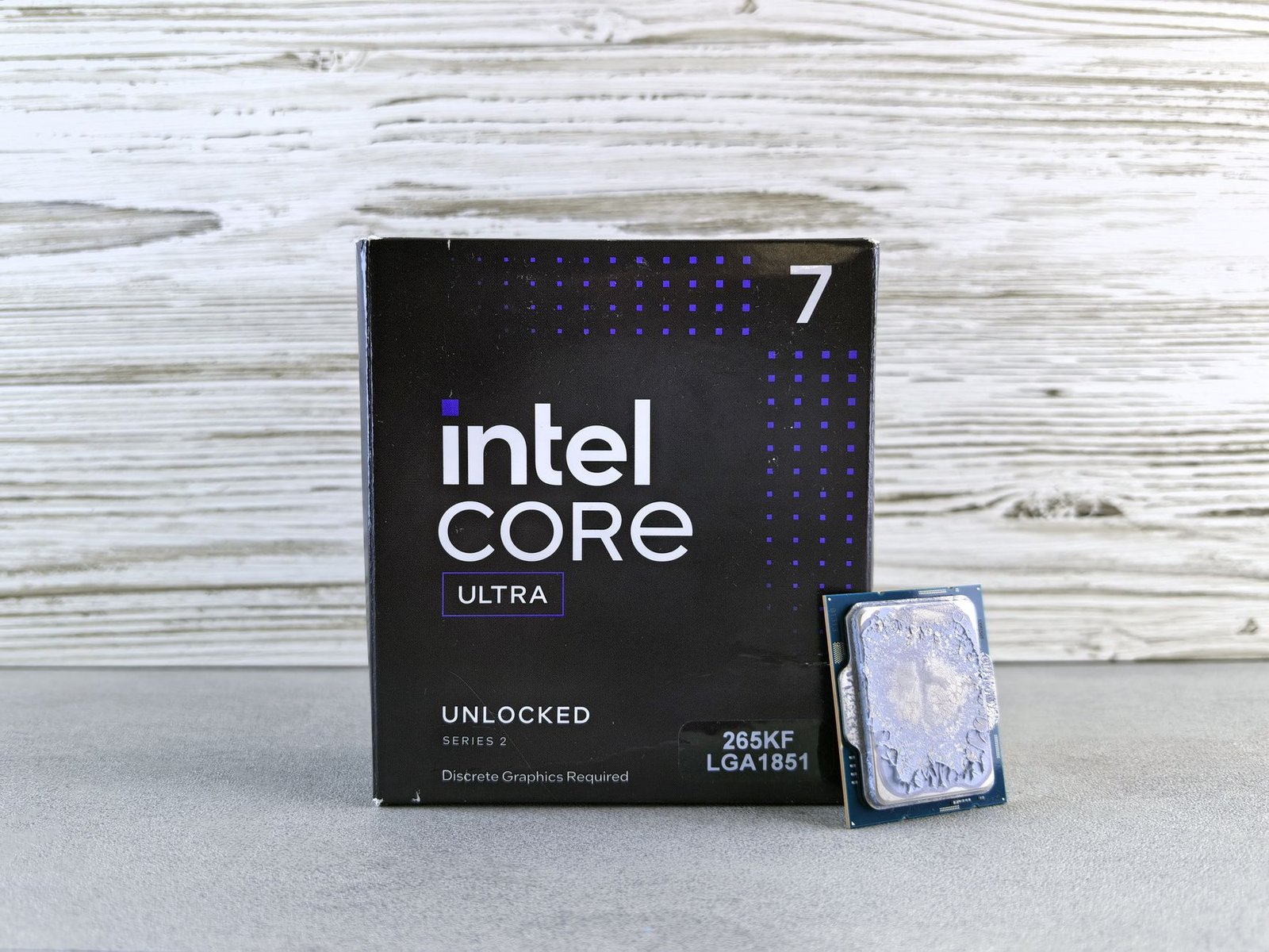 An engineer holding a complex chiplet‑based processor package on a white background, emphasizing multi‑die integration